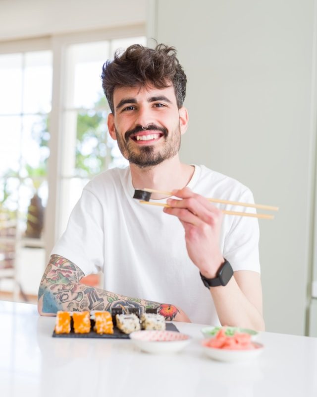 Man eats sushi happily alone