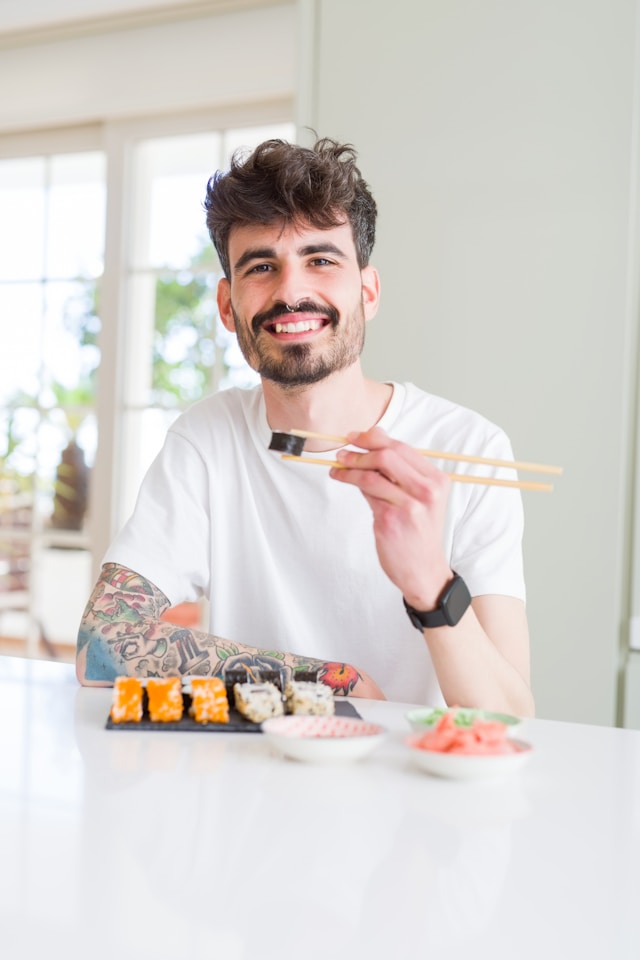 Man eats sushi happily alone